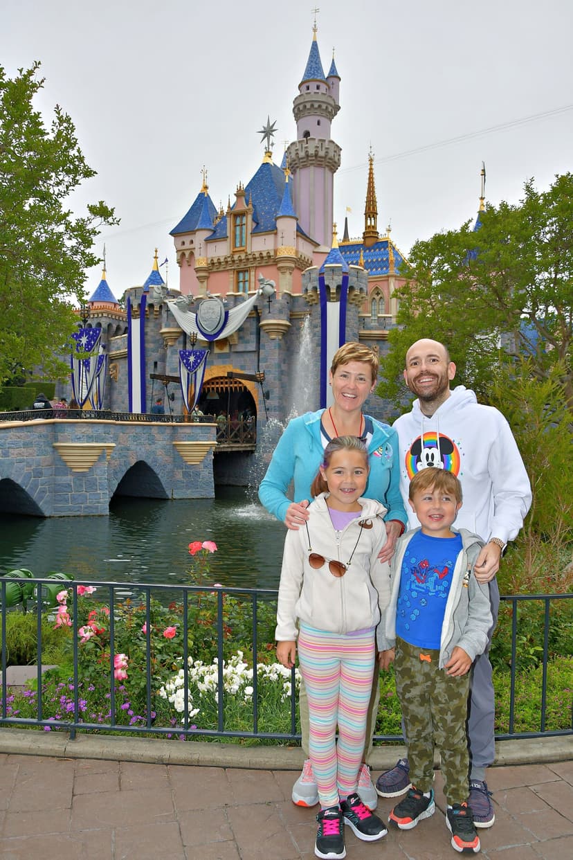 A family poses for a picture in front of a castle