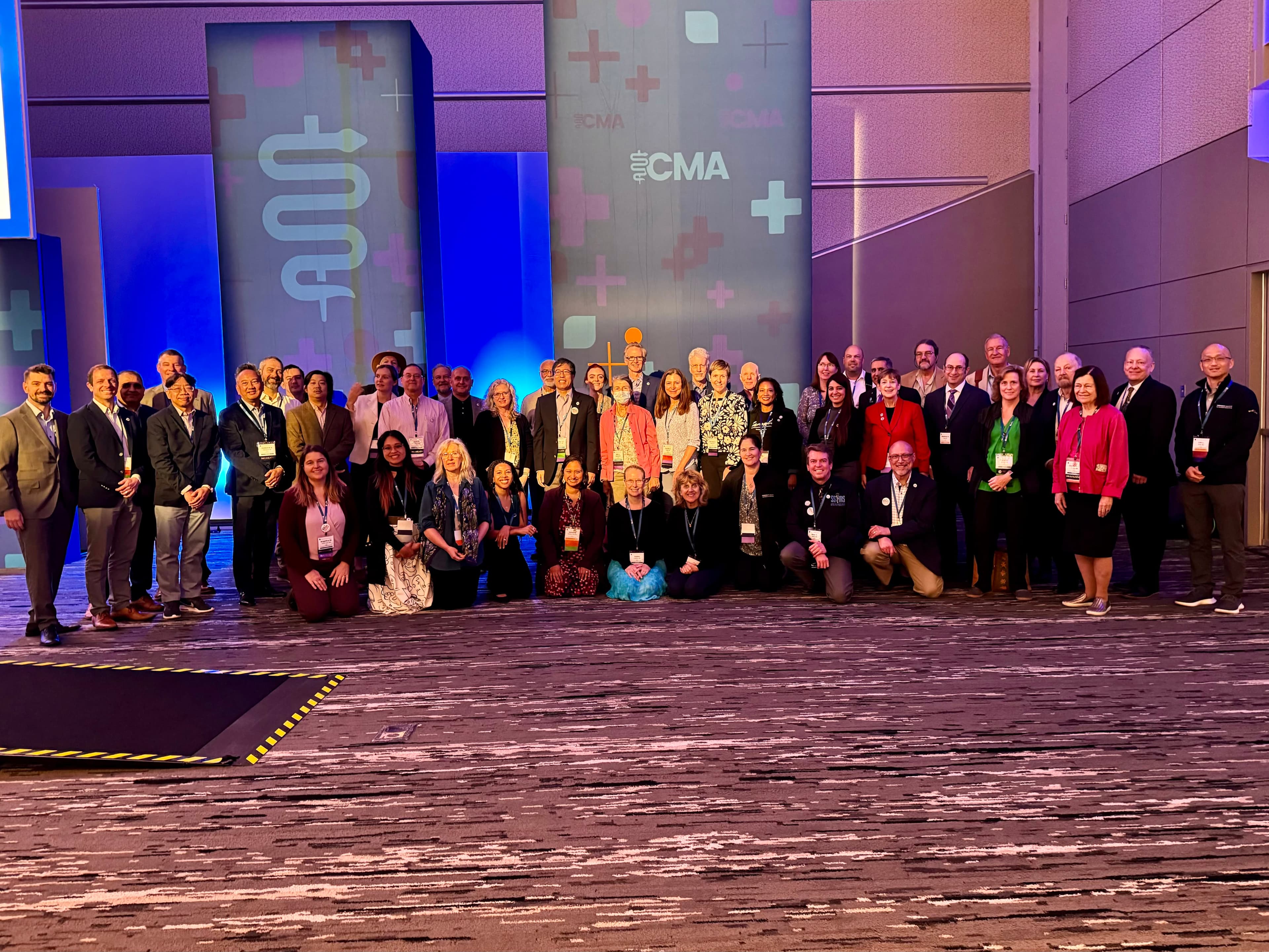 A group of people standing in front of a stage