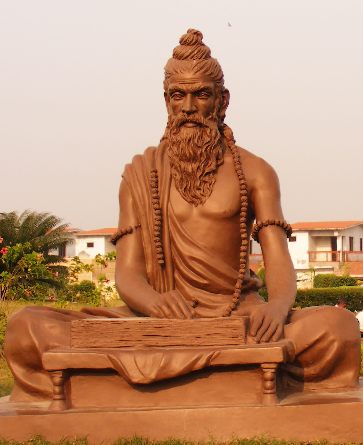 A statue of a man sitting on a bench