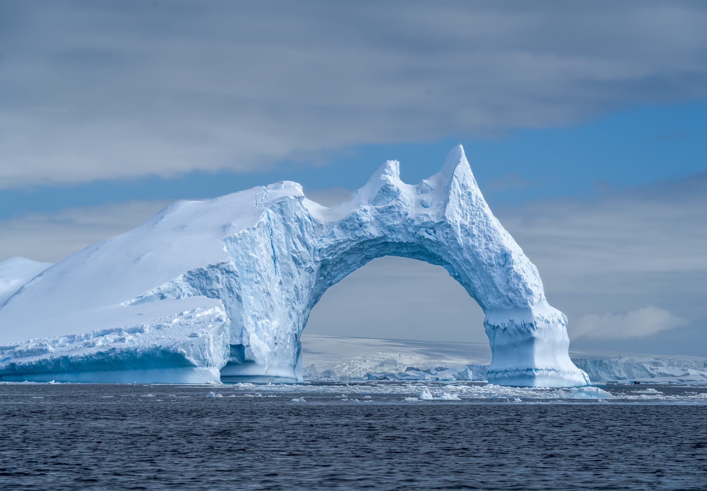 A large iceberg in the middle of the ocean