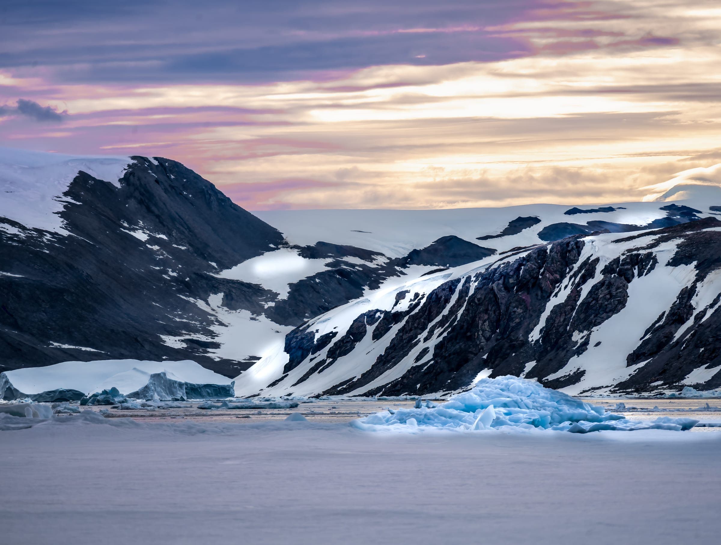 A mountain range covered in snow and ice