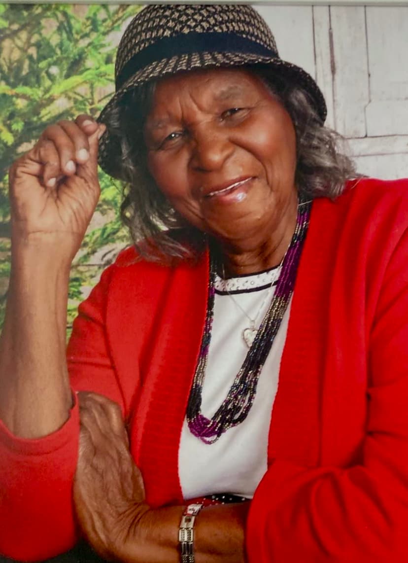 A woman wearing a red sweater and a hat