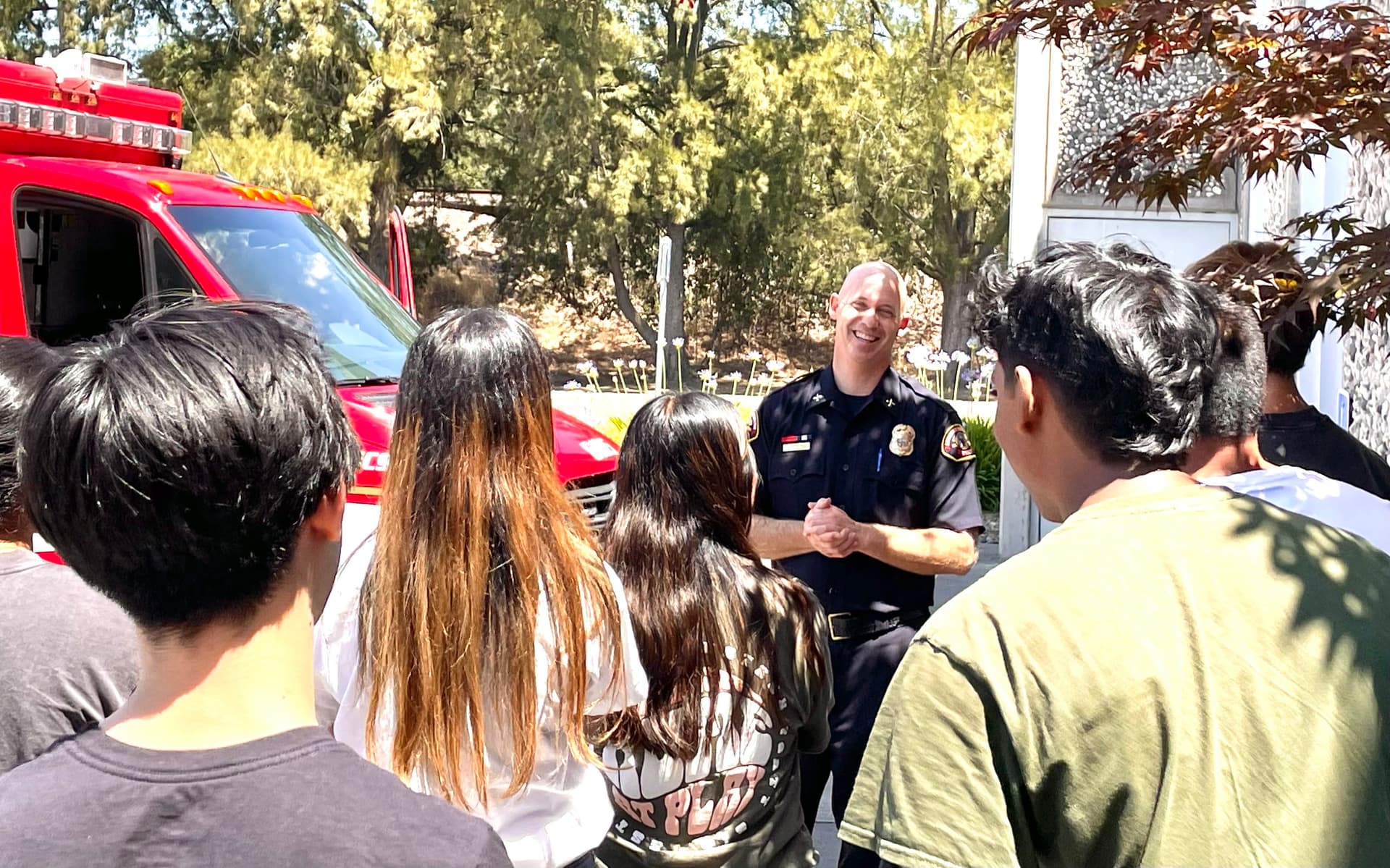 A group of people standing around a fire truck
