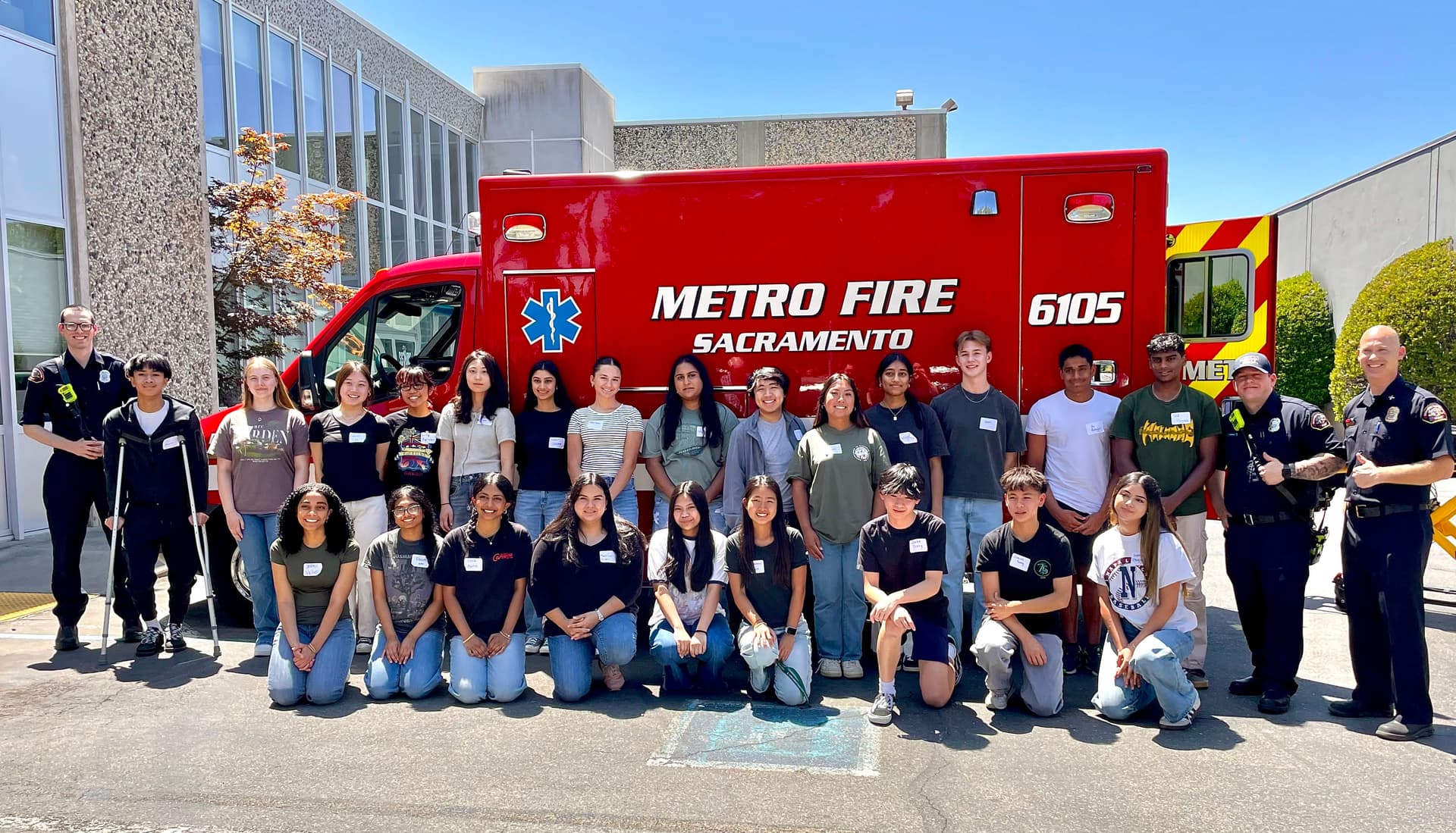 A group of people standing in front of a fire truck