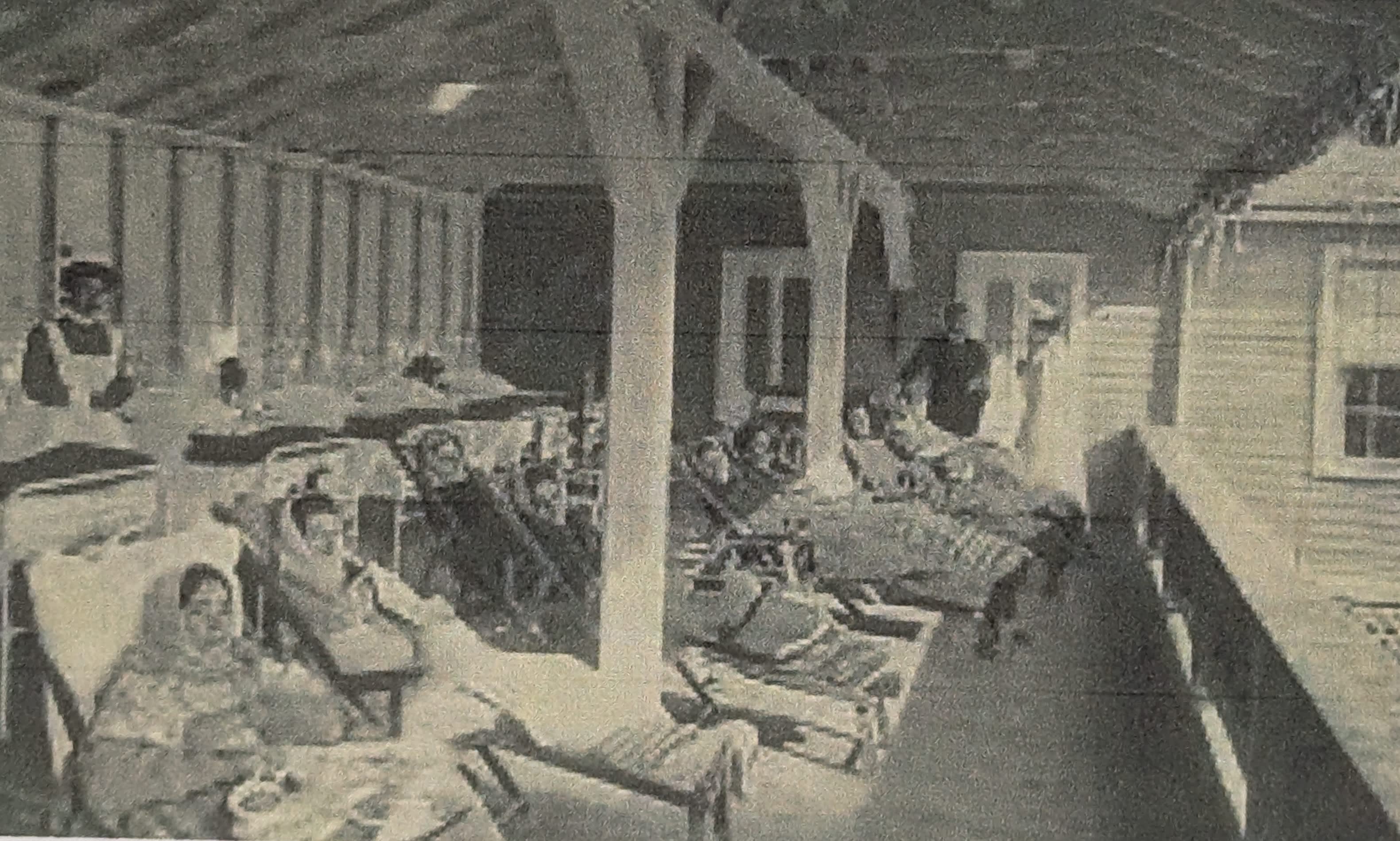 A black and white photo of people in a room