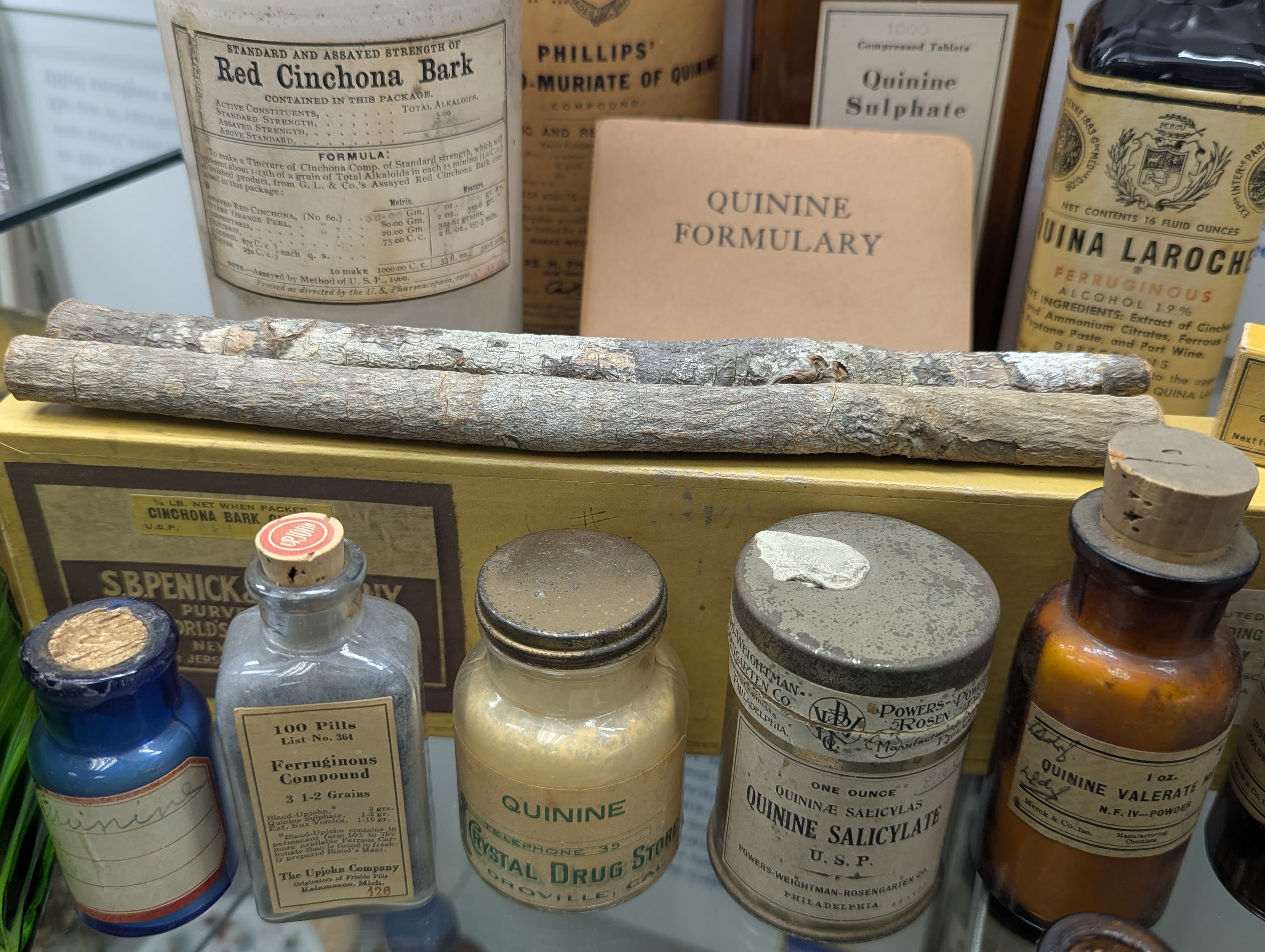 A collection of old medicine bottles and bottles of medicine