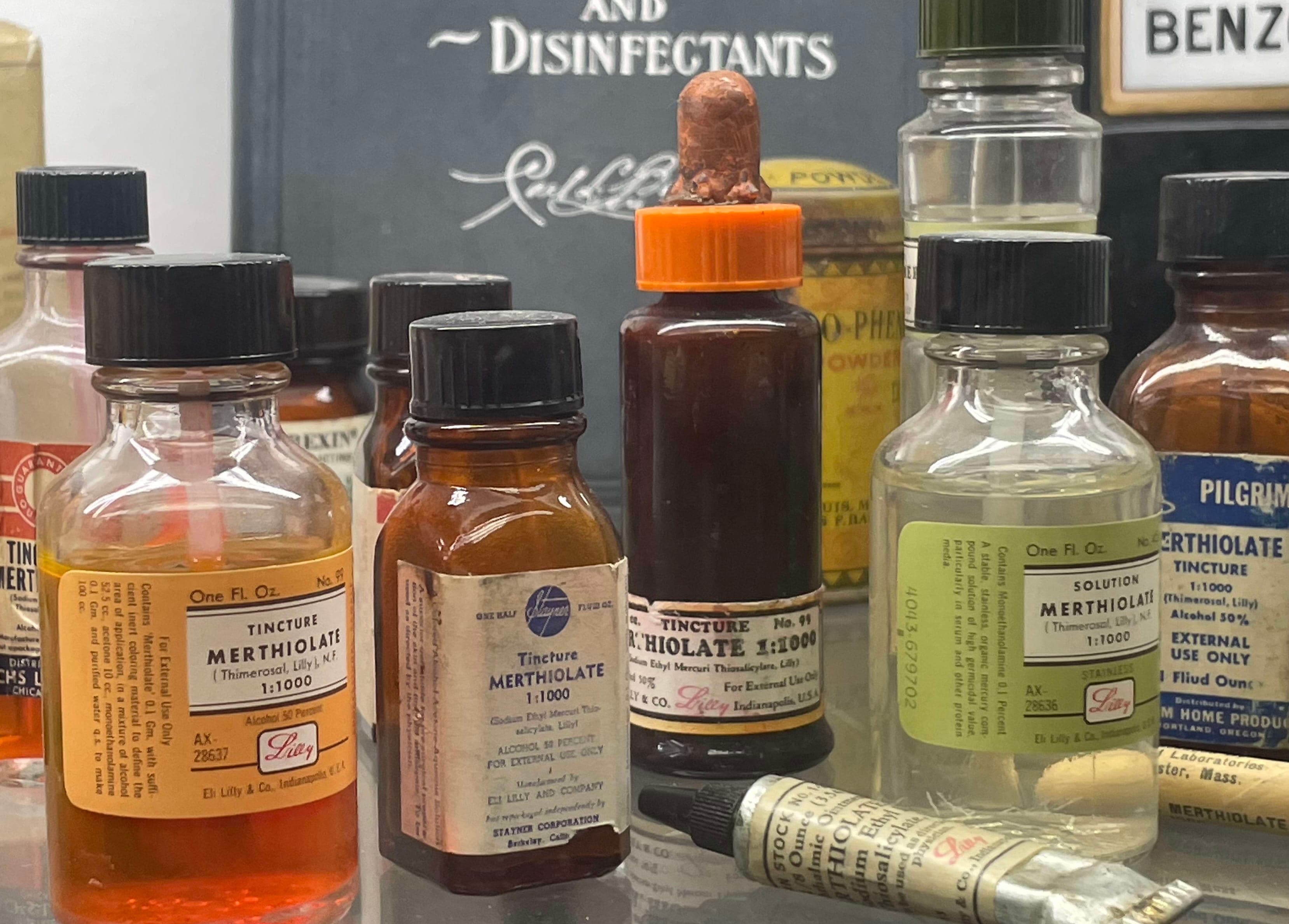 A glass table topped with bottles of medicine