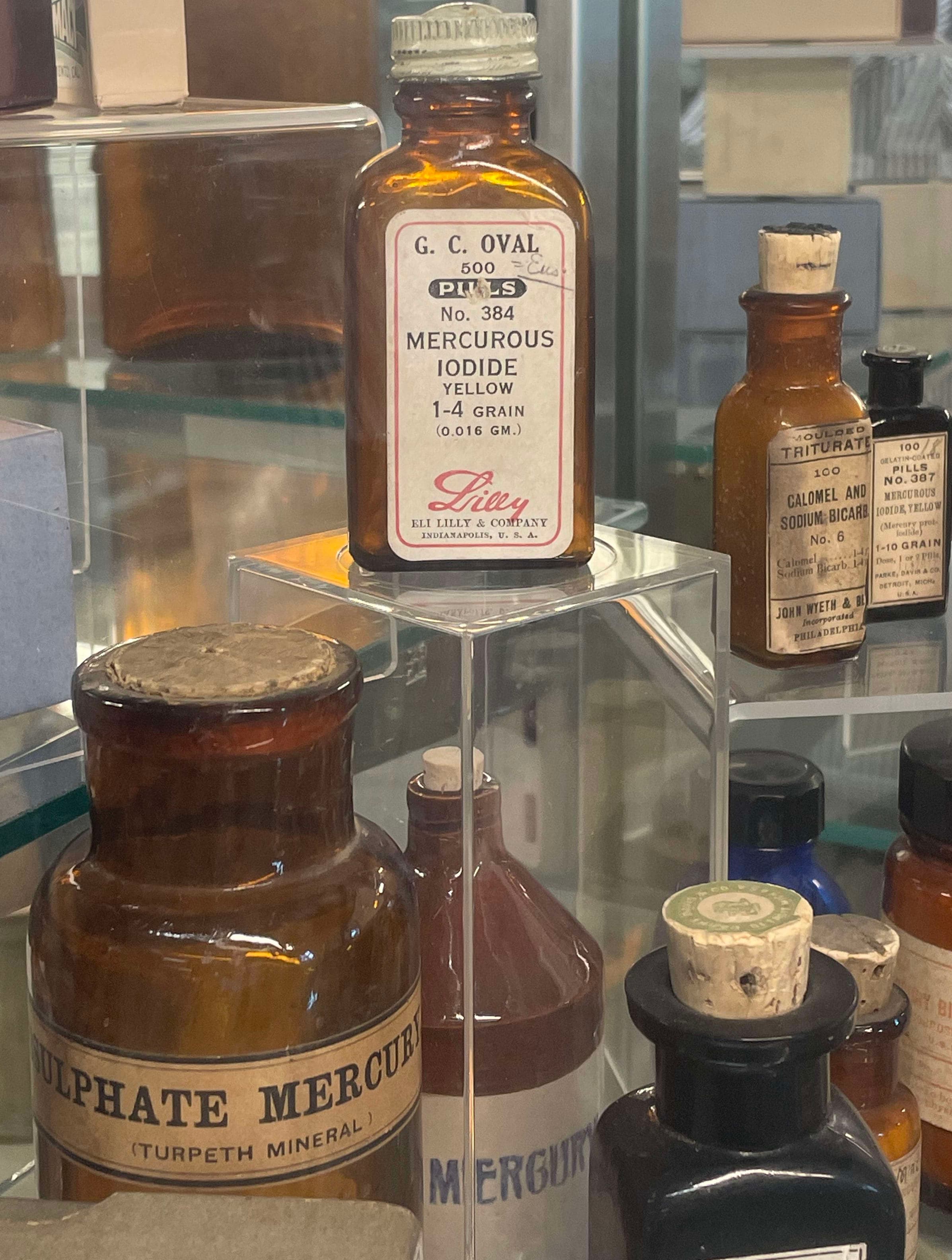 A display case filled with lots of different types of medicine