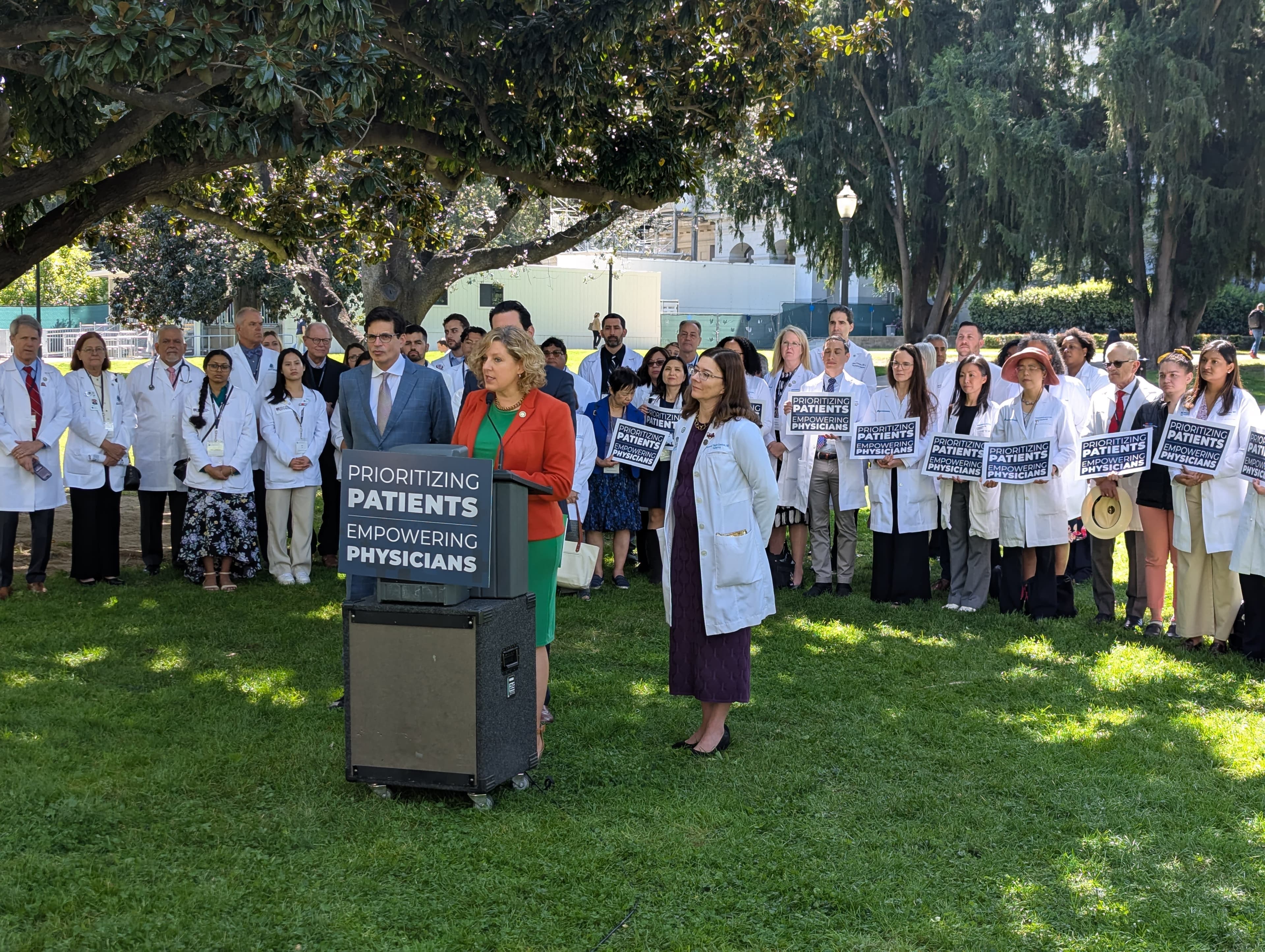 A group of people holding signs in front of a crowd