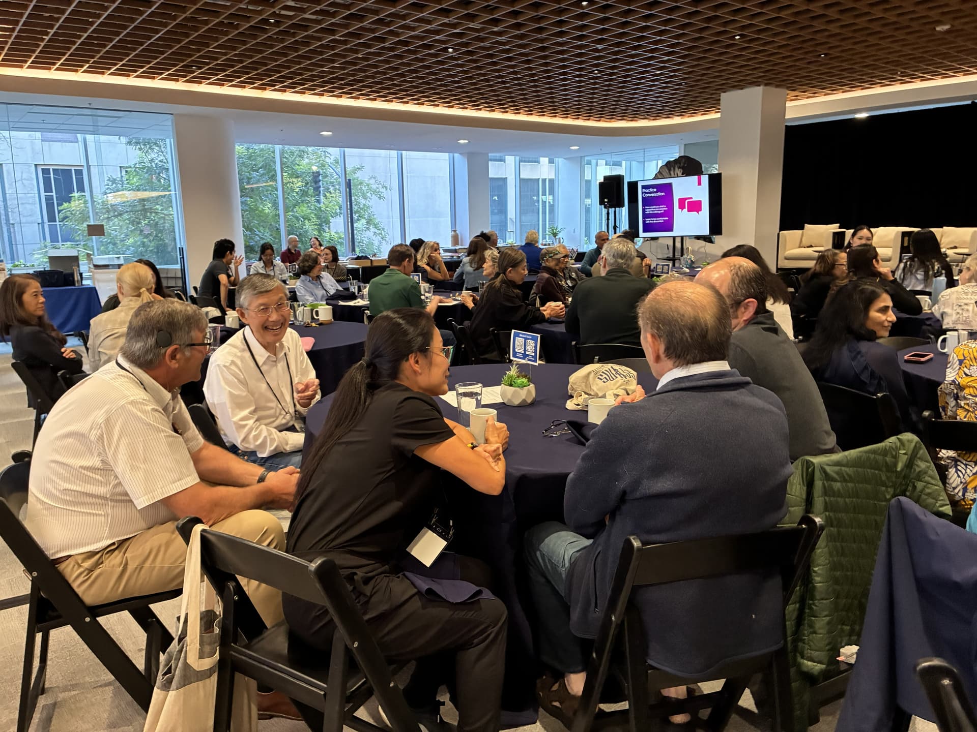 A group of people sitting at tables in a room