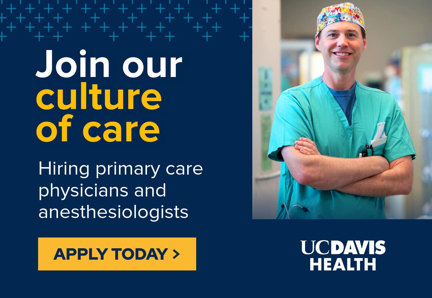 A man in scrubs is smiling for the camera