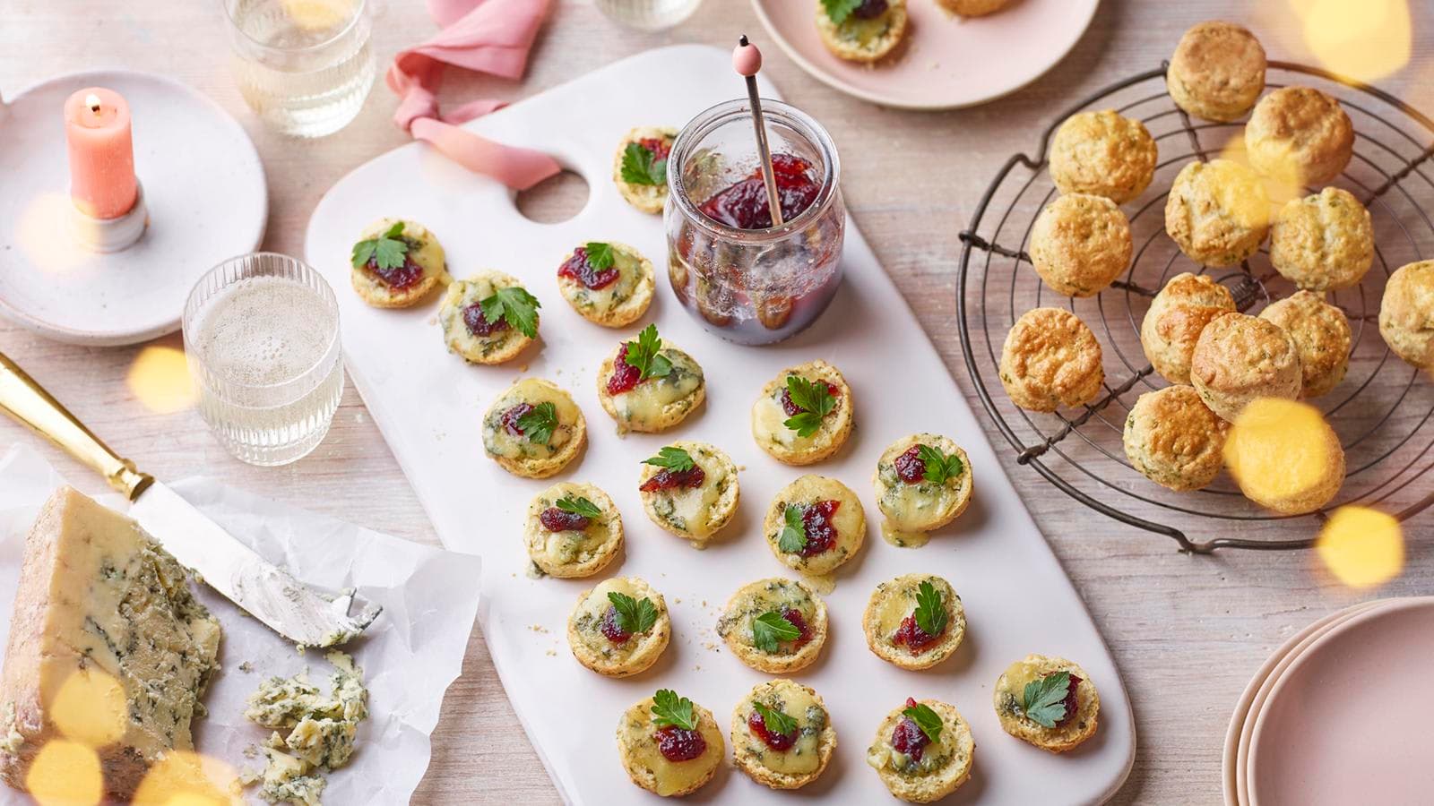 A table topped with plates of food and a jar of jam