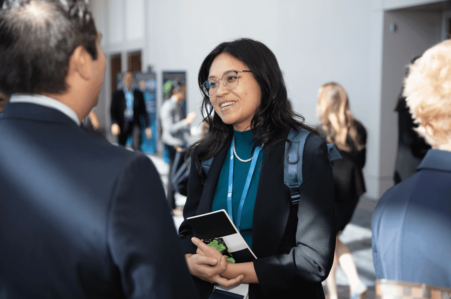 A woman talking to a man in a suit and tie